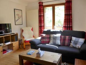 a living room with a couch and a coffee table at Chalet 3* à Arêches, 100m², 8 pers, 4 ch, Pied des Pistes, Cheminée, Terrasse, Wifi - FR-1-342-246 in Beaufort