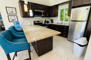 a kitchen with a counter and a refrigerator at Casa Linda Villa 920 - Sosua in Sosúa