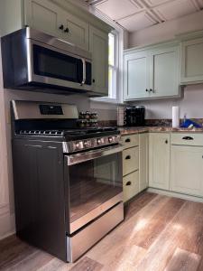 a kitchen with a stainless steel stove and microwave at Guesthouse 214 at Guesthouse Lodging in Millersburg +12 photos