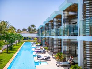 an exterior view of a resort with a swimming pool at Tamala Beach Resort in Kotu