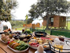 a wooden table with plates of food on it at Bodrum Dome Suites in Bodrum City