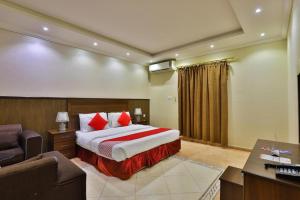 a hotel room with a bed and a desk at نجمة سماء ينبع للشقق المفروشة in Madīnat Yanbu‘ aş Şinā‘īyah