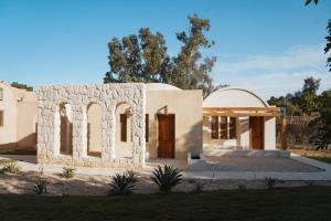 a small house with a door in a yard at Tzila Lodge in Fayoum Center