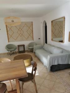 a living room with a couch and a table and chairs at Oasis Golf Villa in Caleta De Fuste +38 photos