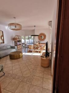 a living room with a couch and a table at Oasis Golf Villa in Caleta De Fuste
