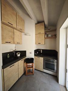 a small kitchen with wooden cabinets and a stove at Chalet Tango in Contrada Sauci Grande +20 photos