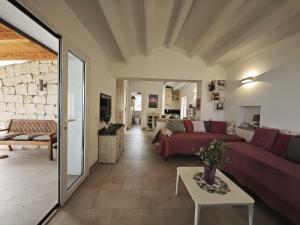 a living room with a couch and a table at Chalet Tango in Contrada Sauci Grande