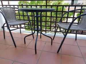 a table and two chairs on a balcony at Apartamento Olivia in Nerja