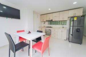 a kitchen with a table and chairs and a refrigerator at Exclusivo Apartaestudio en Pinares- 5 in Pereira +15 photos