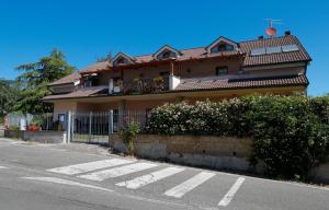 a house with a balcony on the side of a street at La Rosa dei Venti in CastellʼAzzara +6 photos