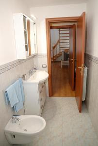 a bathroom with a sink and a toilet and a mirror at La Rosa dei Venti in CastellʼAzzara