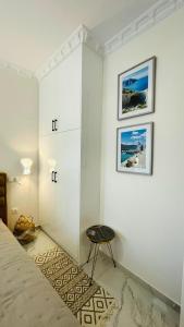 a bedroom with a bed and a table on a wall at Eleni's Green balcony modern apartment by the Sea in Loutraki