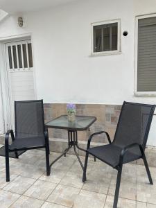 two chairs and a table on a patio at Adoms Rooms in Orfánion +7 photos