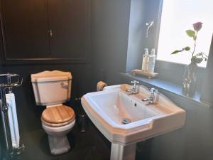 a bathroom with a sink and a toilet at The Balmoral Coach House in Morecambe