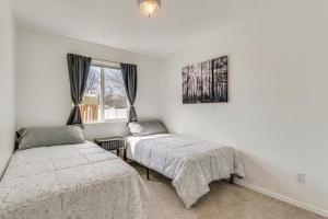a bedroom with two beds and a window at Charming Home with Patio 3 Mi to Hayden Lake! in Hayden