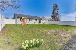 a yard with a playground and a fence at Charming Home with Patio 3 Mi to Hayden Lake! in Hayden