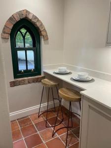 una cucina con bancone, sgabelli e finestra di The Wrens Nest ad Aghadowey