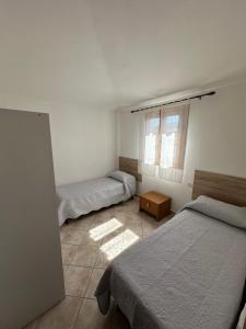a bedroom with two beds and a window at Il Girasole casa vacanze in Porto San Paolo