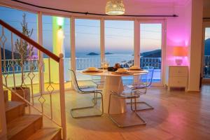 a dining room with a table and chairs on a balcony at Cetinkaya Apart 3 in Kaş