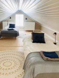 a bedroom with two beds and a ceiling at KokkolaDream - Historical Timber Home in Kokkola