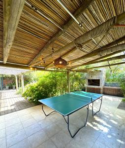 a ping pong table under awning on a patio at Casa espectacular directo sobre el mar in Las Flores