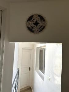a white hallway with a door and a window at Chambre spacieuse avec balcon - salle de bain extérieure privée & breakfast in Saint-Louis