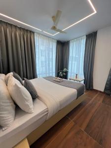 um quarto com uma cama grande em frente às janelas em Wild Wings Premium Hotel em Hyderabad
