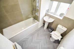 a bathroom with a toilet and a sink at Keith House Workstays UK 4 Bedrooms in Middlesbrough
