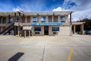 a building with a parking lot in front of it at Americas Best Value Inn-Celina in Celina