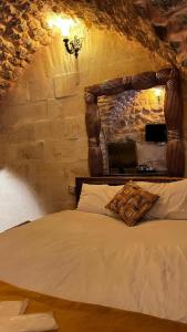 1 dormitorio con 1 cama con cabecero de madera en karagül otel en Sanlıurfa