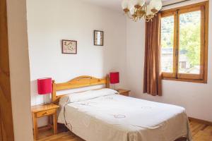 A bed or beds in a room at Apartamentos Grist