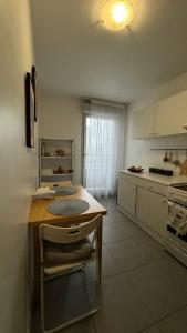 a kitchen with a counter and a table in it at Private room Serenity near Arena La Défense in Nanterre