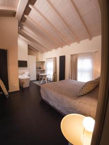 a hotel room with a bed and a desk at Palazzo Gozzi Bed & Beauty in Parma