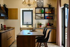 a kitchen with a table and two chairs in it at Paradisea Rocco's Villa in Taormina