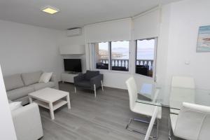 a living room with a couch and a glass table at Villas Romanas with best sunsets and views in Cartagena