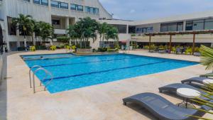 a swimming pool in front of a building at Hotel Casino Internacional in Cúcuta