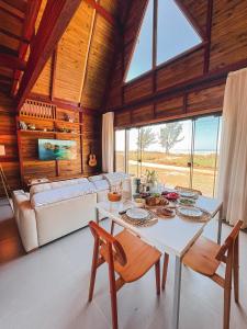 a living room with a table and a couch at O Chalé da Praia in Jaguaruna