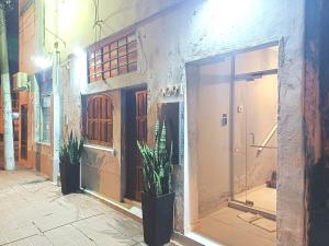 a building with a window and plants on a street at ALFA SWEET APARTS in Formosa