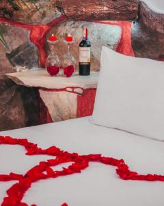 two bottles of wine sitting on a table with red roses at Kashama Eco Resort & Spa in Santo Domingo de los Colorados +34 photos