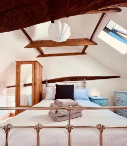 a bedroom with a large bed with a ceiling at The Hideout in Linton