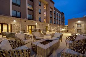 a patio with chairs and a fire pit in front of a building at Hampton Inn Queen Creek, AZ in Queen Creek