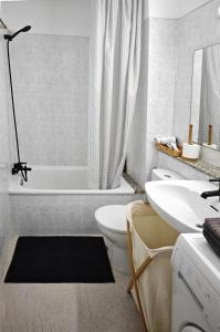 a bathroom with a tub and a toilet and a sink at Blanco&Azul - Ocean View Balcony, Pool and Perfect Location in Playa de las Americas