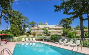 a large house with a swimming pool and chairs at The Land O Nod in Eureka Springs