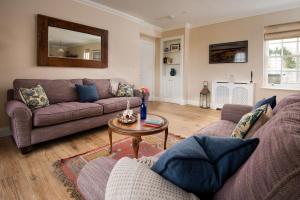 a living room with a couch and a table at Fairnington East Wing in Kelso