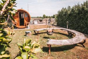 a wooden bench with a swing in a yard at CRASH'NSTAY - Sebastian in Sprang-Capelle