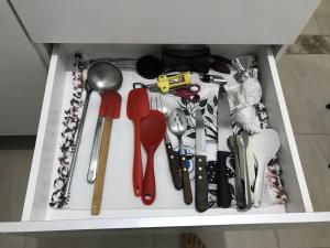 a drawer filled with lots of utensils at Casa Charmosa in Taubaté