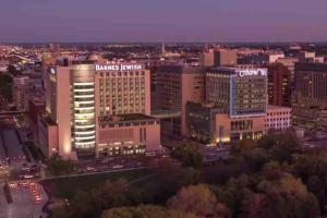 a view of a large city at night at Urban 1BR Nurse's Retreat Barnes & Children's in Tower Grove +4 photos
