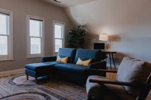a living room with a blue couch and a chair at Modern 1BR-1BA Walk to SSM SLU Hospital Grand in Tower Grove