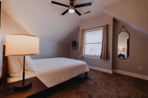 a bedroom with a bed with a ceiling fan and a window at Modern 1BR-1BA Walk to SSM SLU Hospital Grand in Tower Grove