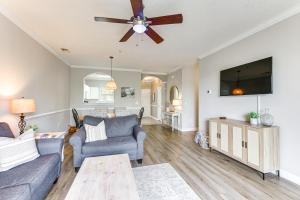 a living room with a couch and a ceiling fan at North Myrtle Beach Condo Rental with Pool Access! in North Myrtle Beach